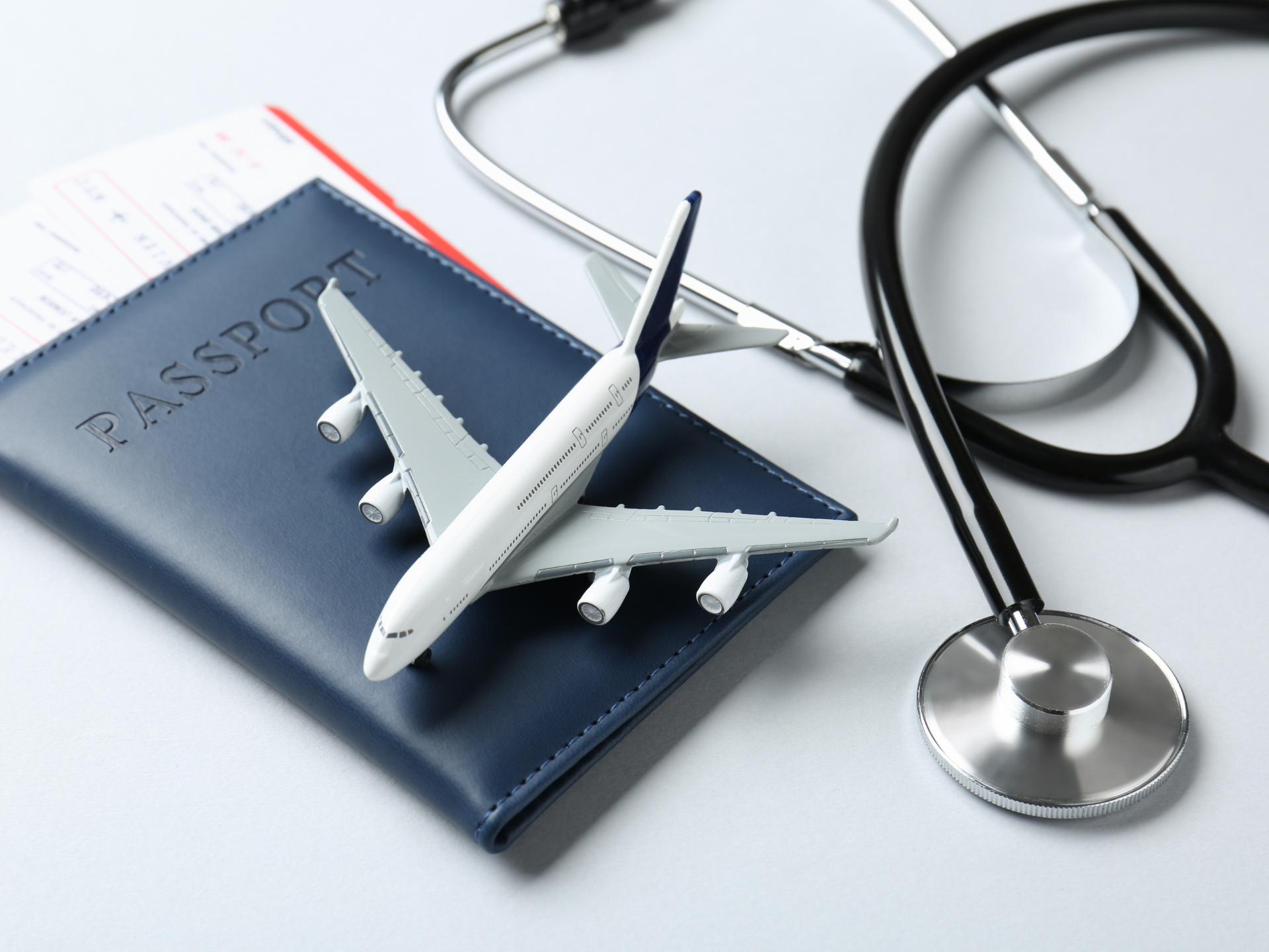 International medical travel — passport, airplane and stethoscope